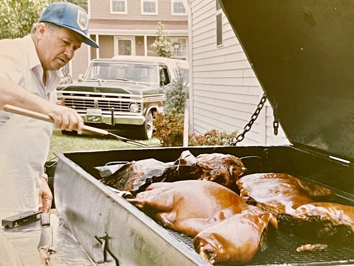 Chuck Allen Sr. tending a whole-hog roast in the backyard